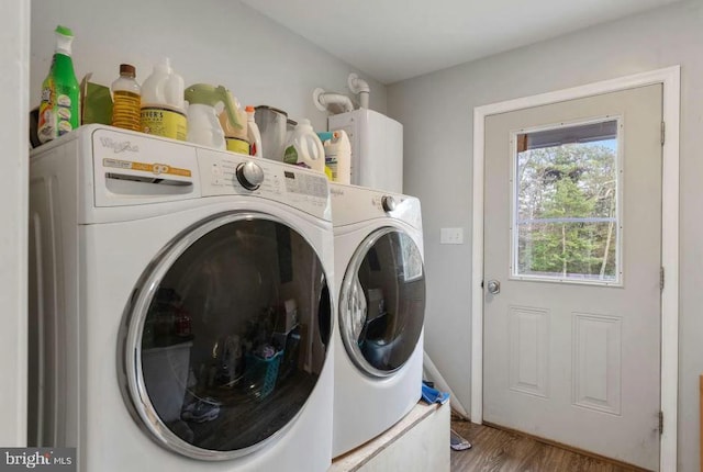 laundry room featuring washing machine and dryer and wood-type flooring