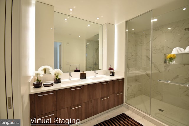 bathroom featuring vanity and a shower with door