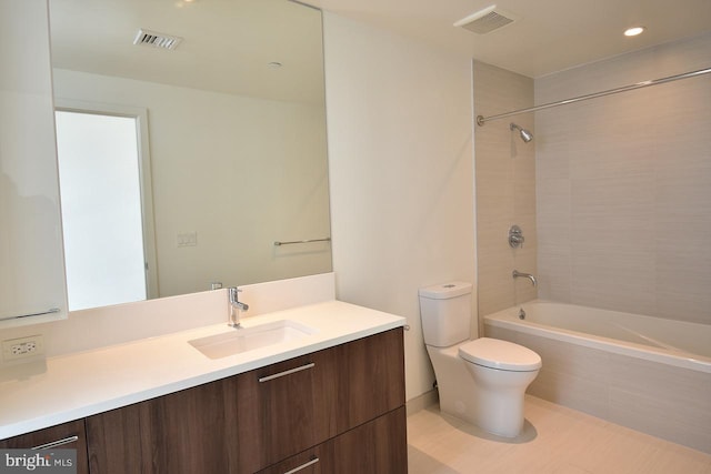 full bathroom featuring vanity, tiled shower / bath, and toilet