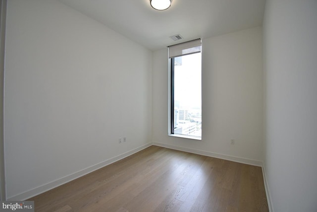 spare room with light hardwood / wood-style flooring