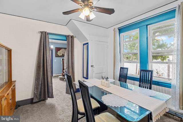 carpeted dining room with a baseboard radiator and ceiling fan