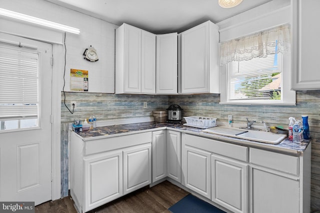 kitchen featuring sink, dark wood-type flooring, and white cabinets