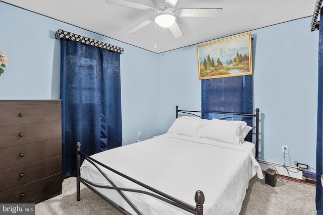 carpeted bedroom featuring ceiling fan and baseboard heating