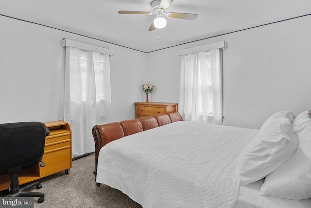 bedroom with ceiling fan and light carpet