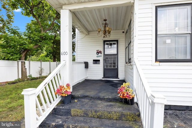 view of exterior entry featuring covered porch