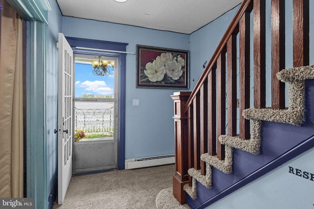 carpeted entrance foyer featuring an inviting chandelier and baseboard heating