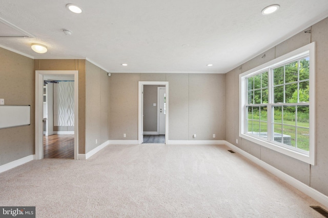 unfurnished room with light carpet, visible vents, and recessed lighting