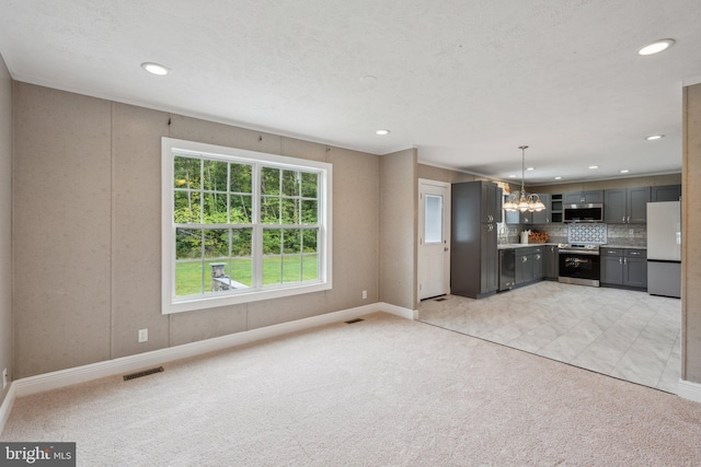 kitchen featuring light carpet, visible vents, decorative backsplash, appliances with stainless steel finishes, and gray cabinetry