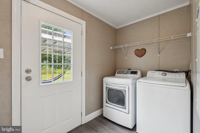 washroom with washing machine and dryer, laundry area, plenty of natural light, and wood finished floors