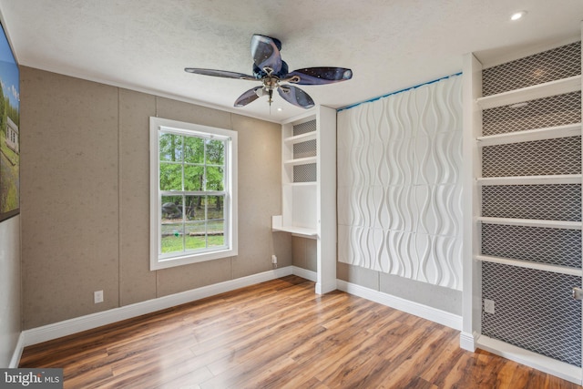 unfurnished bedroom with a textured ceiling, recessed lighting, wood finished floors, a ceiling fan, and baseboards