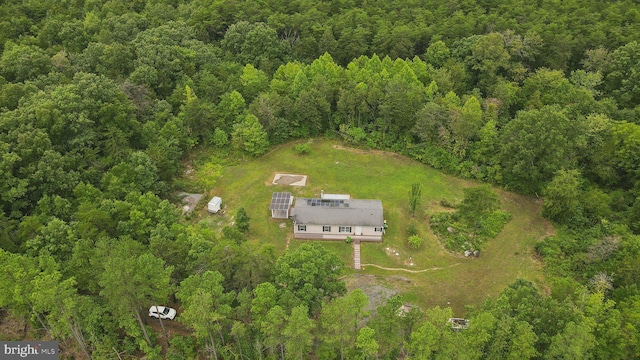 bird's eye view featuring a wooded view