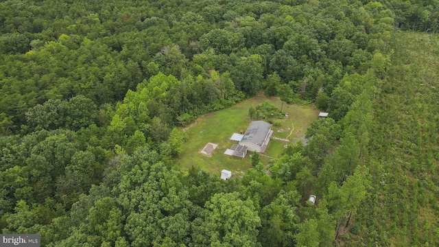 birds eye view of property with a view of trees