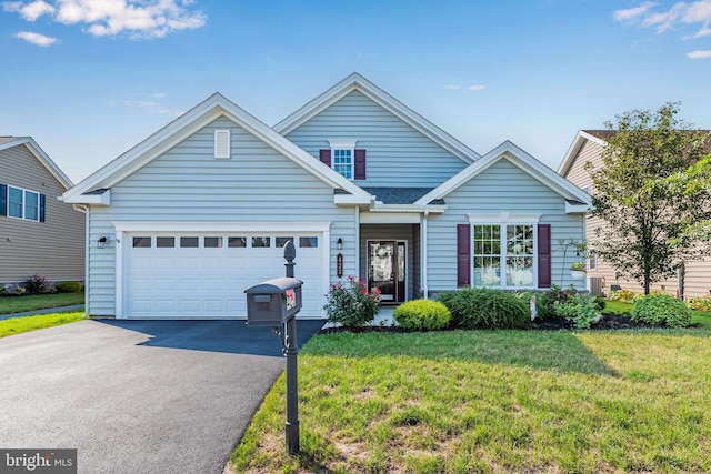 view of front of home with a garage and a front lawn