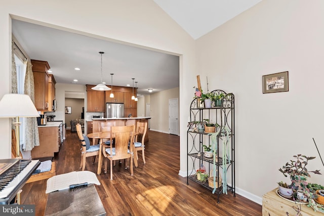 dining area with lofted ceiling and dark hardwood / wood-style floors