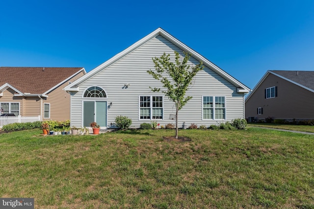 rear view of property with a lawn