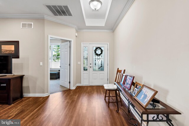 entryway with dark wood-type flooring and crown molding