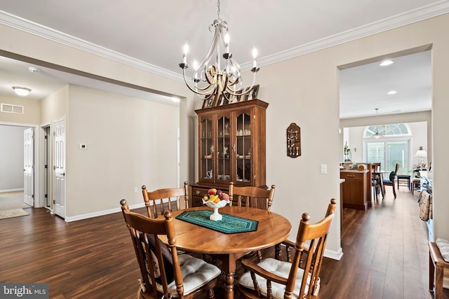 dining room with ornamental molding and dark hardwood / wood-style floors