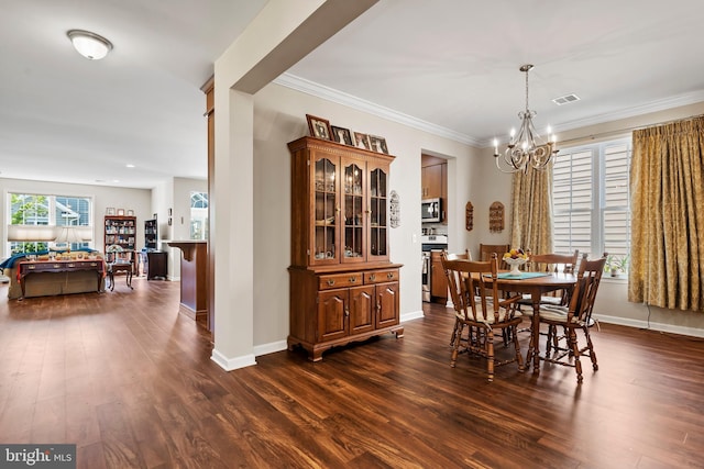 dining room featuring ornamental molding, dark hardwood / wood-style floors, and a chandelier