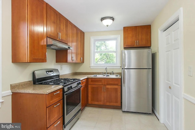 kitchen featuring appliances with stainless steel finishes, sink, and light tile patterned floors