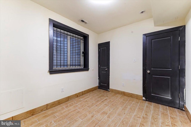 spare room featuring light hardwood / wood-style flooring