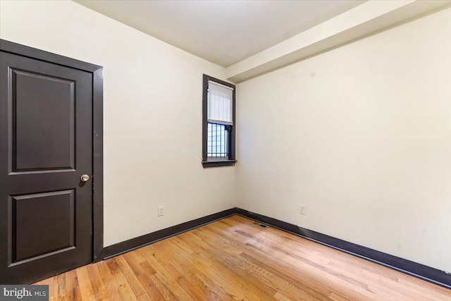 spare room featuring light hardwood / wood-style floors