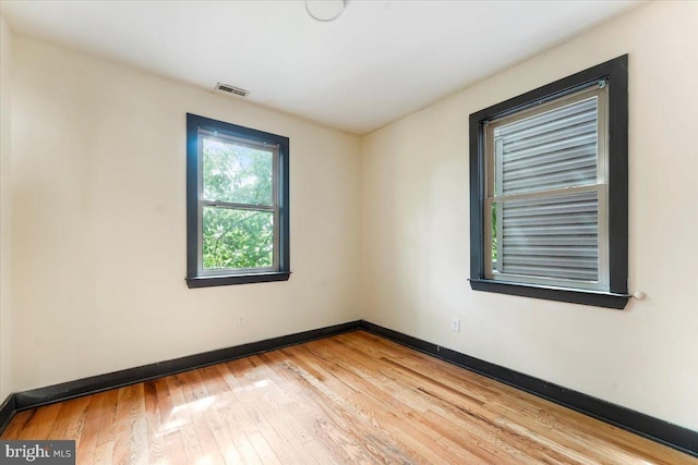 spare room with light hardwood / wood-style floors