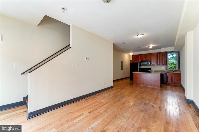 unfurnished living room featuring light wood-type flooring