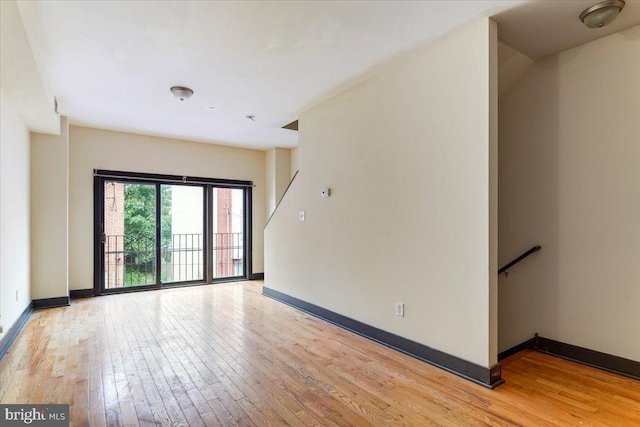 spare room featuring light wood-type flooring