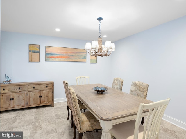 dining space with light tile patterned flooring and a chandelier