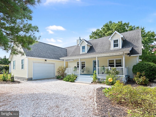 new england style home featuring a porch and a garage