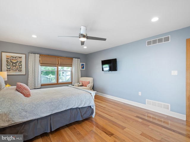 bedroom with light hardwood / wood-style flooring and ceiling fan