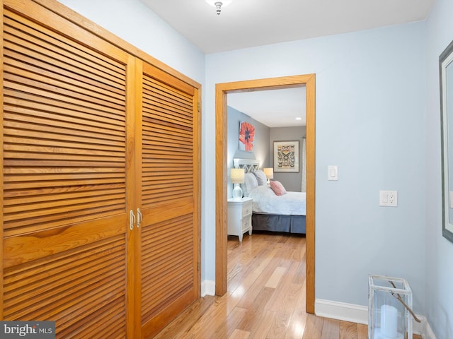 hallway with light hardwood / wood-style flooring