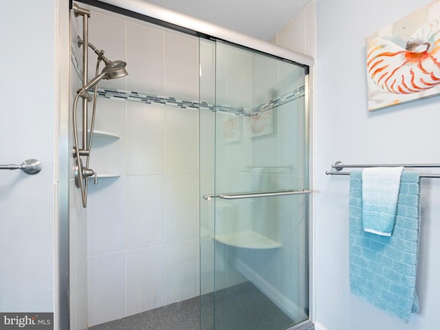 bathroom featuring a shower with shower door