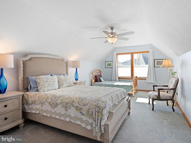 bedroom featuring ceiling fan, a textured ceiling, lofted ceiling, and carpet