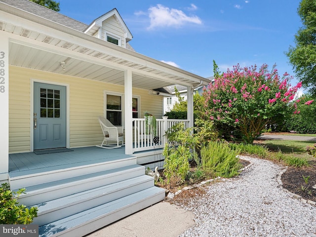 view of exterior entry with a porch