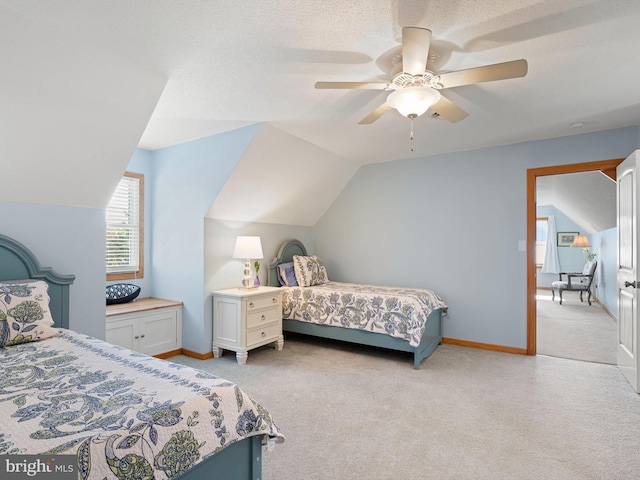 carpeted bedroom featuring ceiling fan, a textured ceiling, and vaulted ceiling