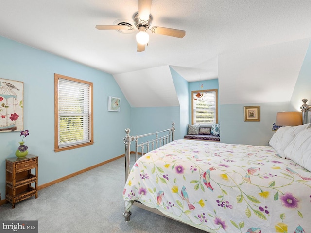 carpeted bedroom featuring ceiling fan, a textured ceiling, and vaulted ceiling