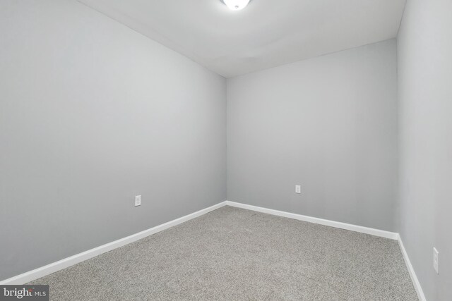 carpeted empty room with baseboards