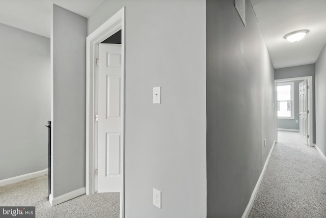 hallway with light colored carpet