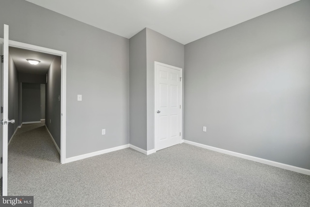 unfurnished bedroom with baseboards and carpet flooring