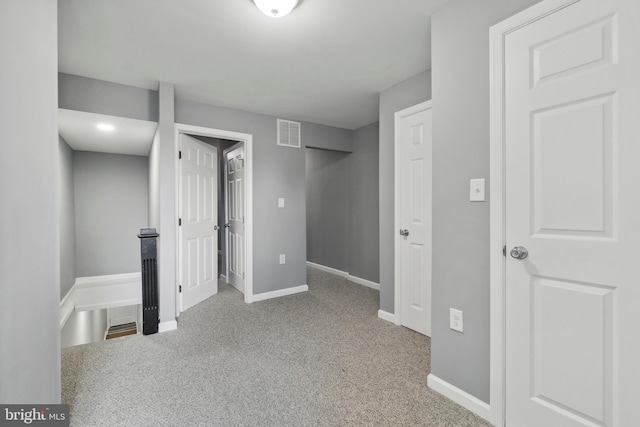 unfurnished bedroom featuring light carpet