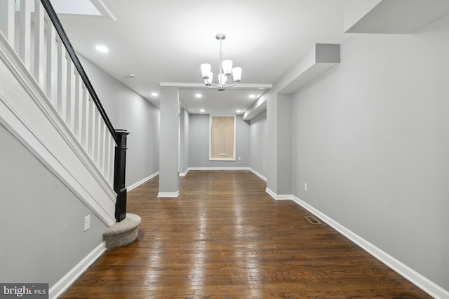 foyer featuring dark hardwood / wood-style flooring and a notable chandelier