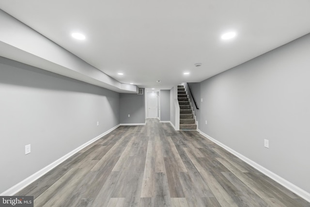 basement with hardwood / wood-style floors