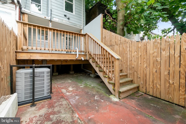 wooden terrace with a patio area and central air condition unit