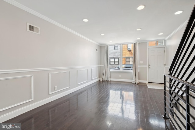 interior space with dark hardwood / wood-style flooring and ornamental molding