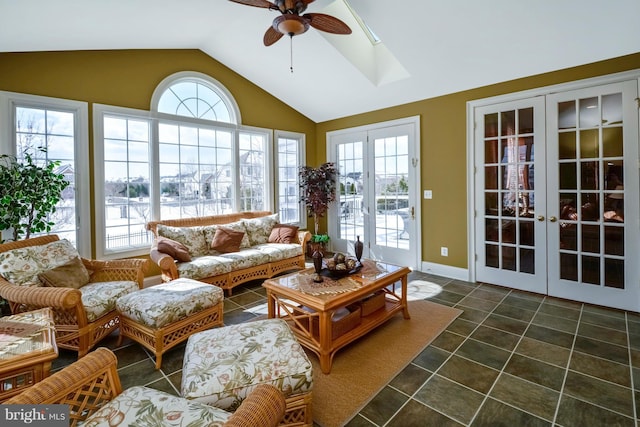 sunroom / solarium with vaulted ceiling with skylight, french doors, and ceiling fan