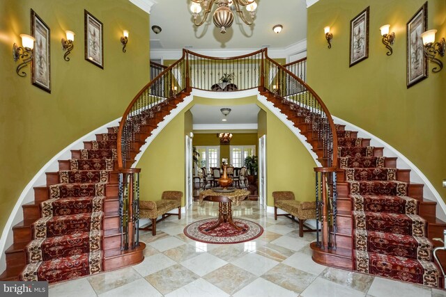 interior space featuring ornamental molding and a chandelier