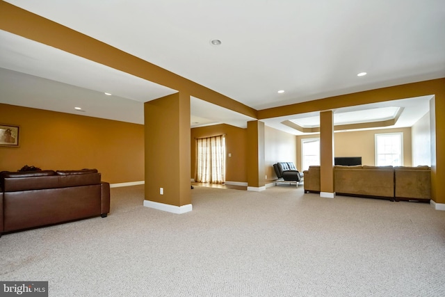 carpeted living room with recessed lighting, baseboards, and a tray ceiling