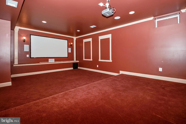 carpeted home theater room with recessed lighting, baseboards, and ornamental molding