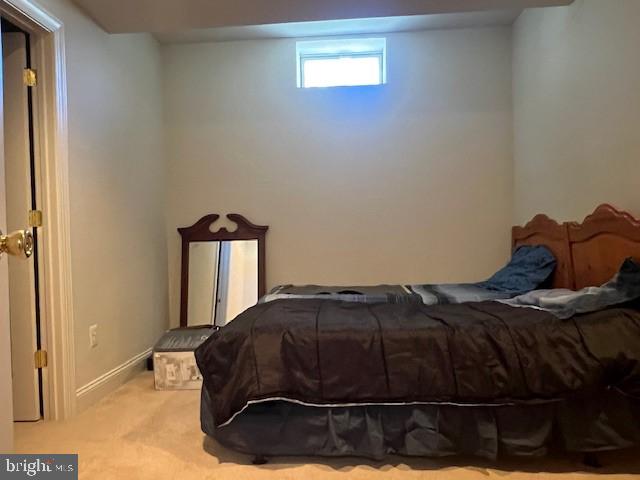 bedroom with carpet flooring and baseboards